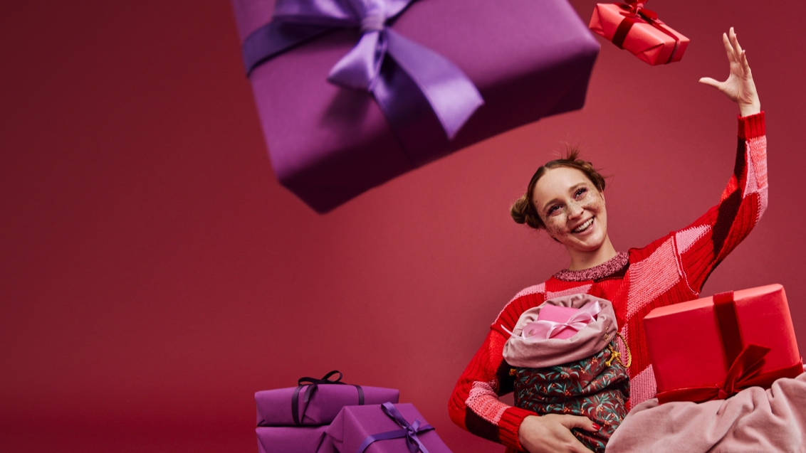 woman throwing a purple gift box in the air