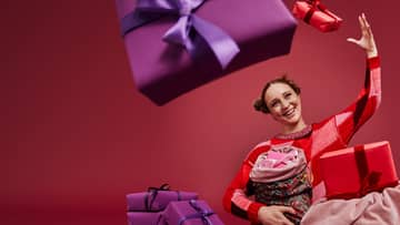 woman throwing a purple gift box in the air