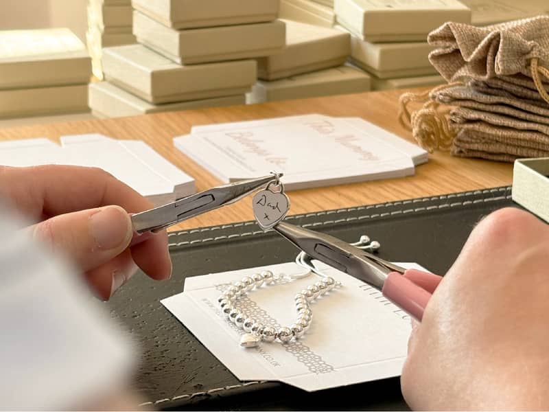 A teammate packaging a jewellery order