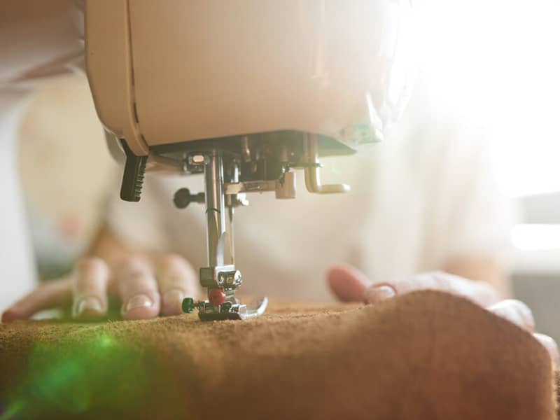 Once the leather pieces have been cut from our unique patterns, the pieces are glued and machine stitched into place.