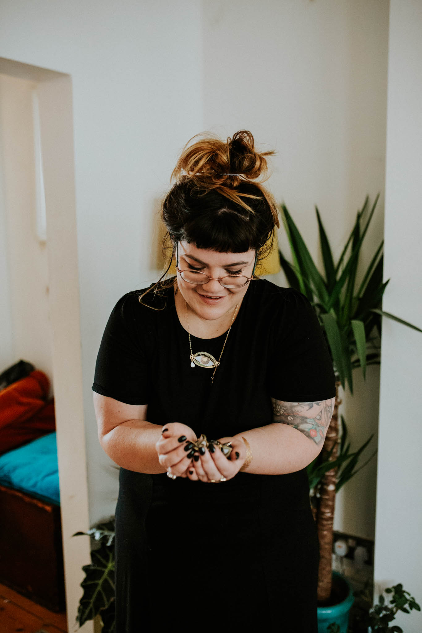 Katy holding enamel pins 