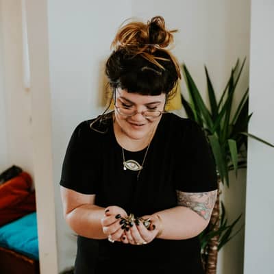 Katy holding enamel pins