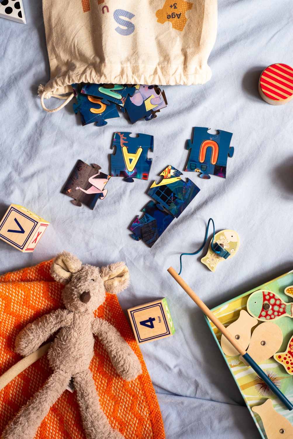 Rumpuspuss personalised jigsaw pieces and bag amongst other toys