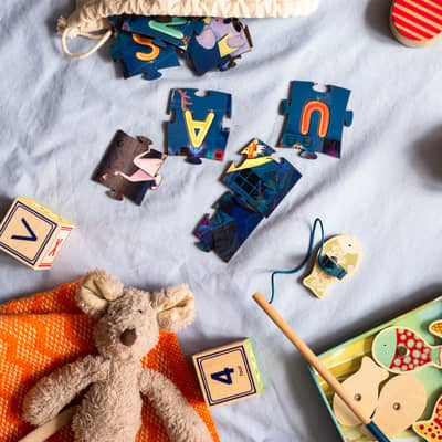 Rumpuspuss personalised jigsaw pieces and bag amongst other toys