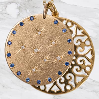 9ct Yellow Gold medal with set Diamonds and Blue sapphires with a large lace flower disc pendant