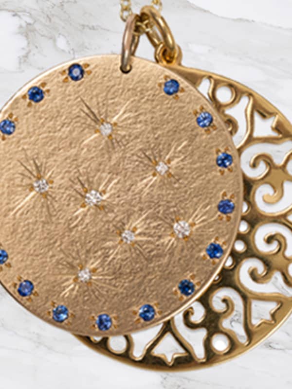 9ct Yellow Gold medal with set Diamonds and Blue sapphires with a large lace flower disc pendant