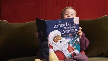 Kid holding personalised Christmas book