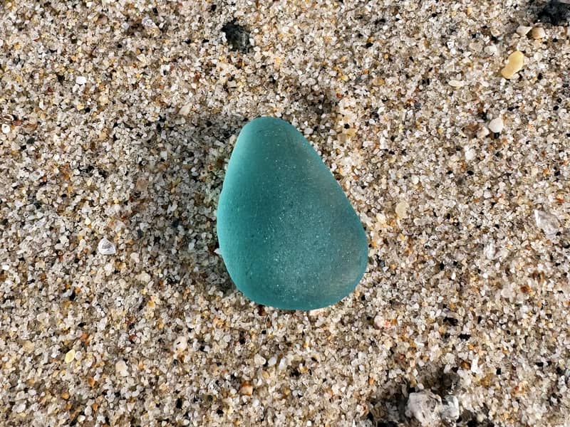 Turquoise sea glass on a beach in Cornwall