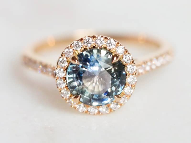 Bespoke Teal Sapphire and Rose Gold diamond halo ring.