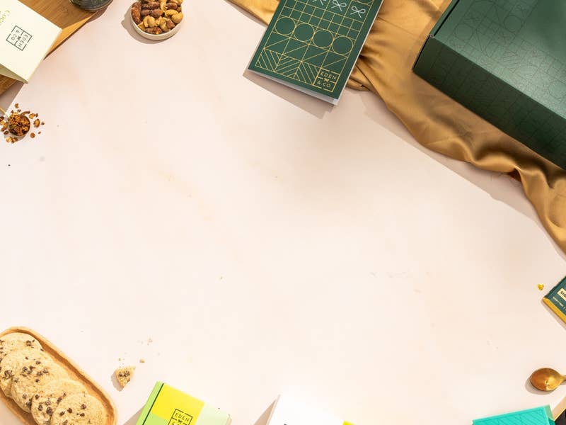 Green EDEN & CO hamper with products surrounding it