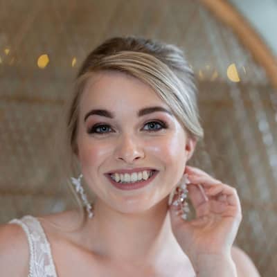 Bride wearing hand beaded earrings.