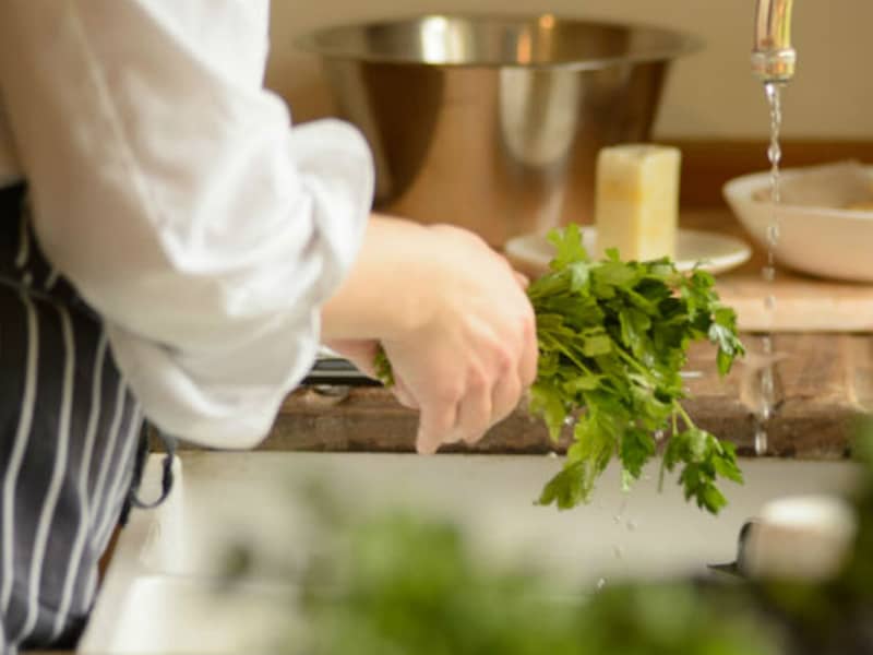 Gathering herbs from the potager.