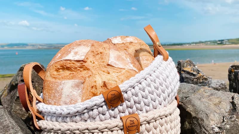 Image bread in crochet basket with leather handles