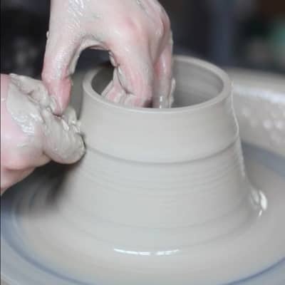 Throwing clay on the potter's wheel