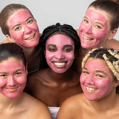 5 girls in pink clay masks