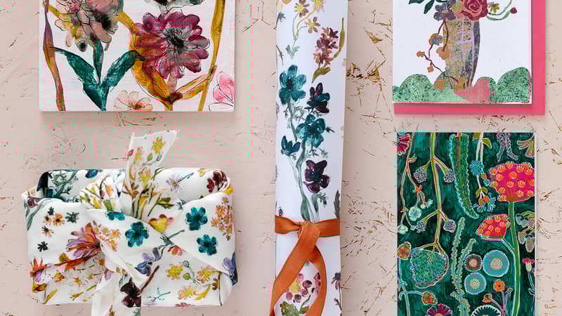 A Floradore product flatlay featuring wrapping paper, 2023 calendar, furoshiki wraps and postcards.