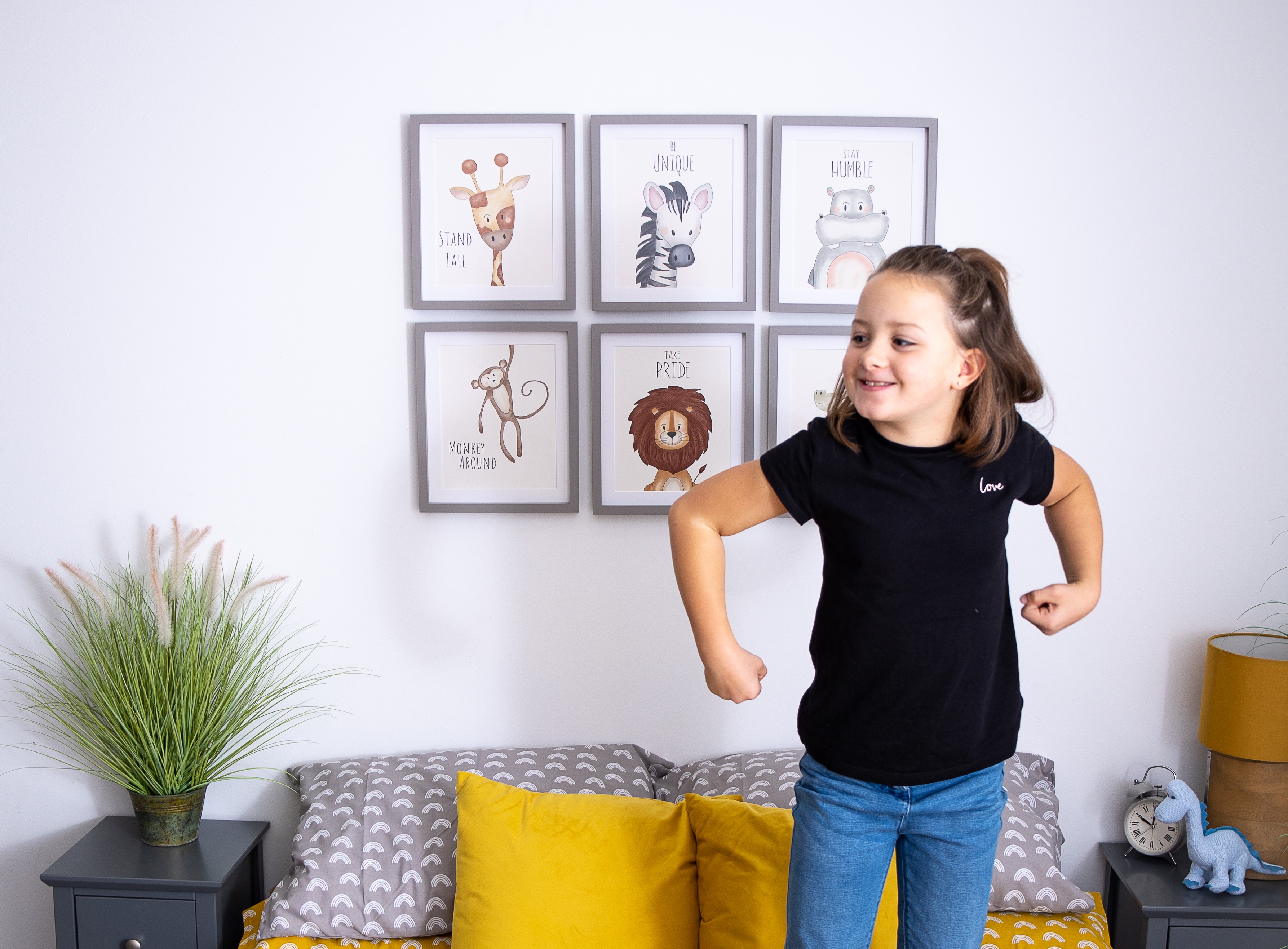 Safari animal prints hanging above bed