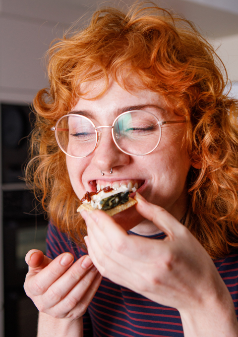 someone enjoying award-winning honestly tasty plant-based cheese