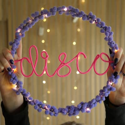 Personalised disco hoop light with lilac pom poms and neon pink writing