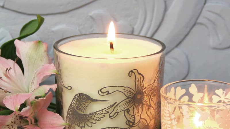 Natural wax candles in printed glassware
