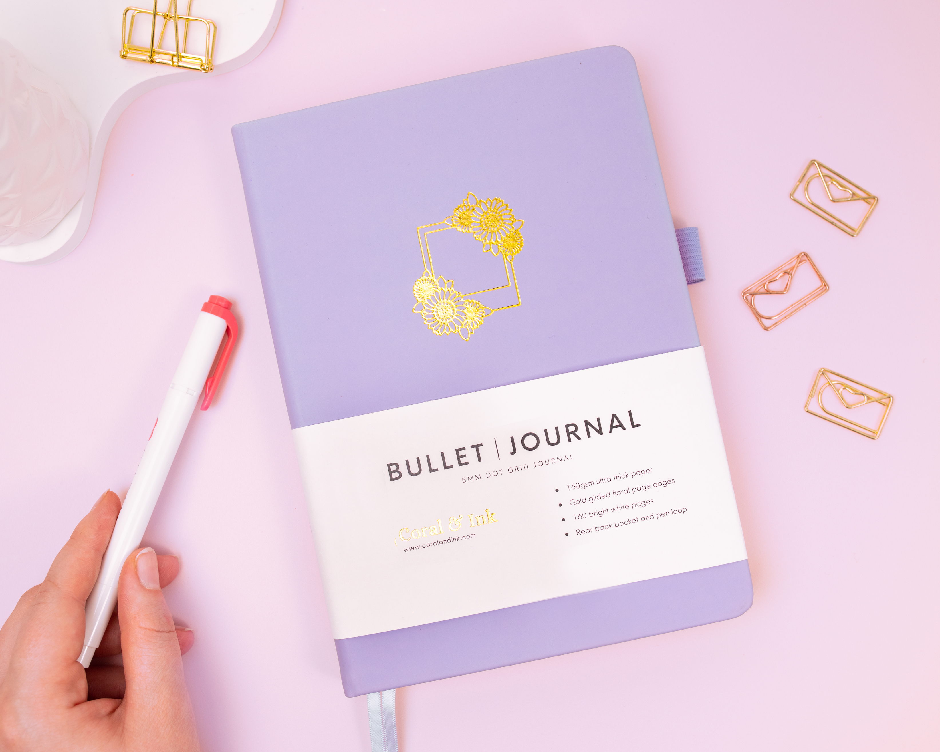 Coral & Ink's purple sunflower bullet journal photographed next to a mild red Zebra Mildliner highlighter pen