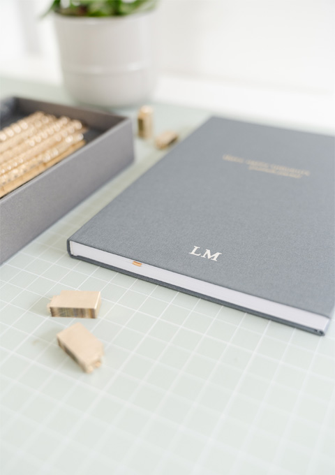 brass type sitting on the desk in front of a personalised gratitude journal