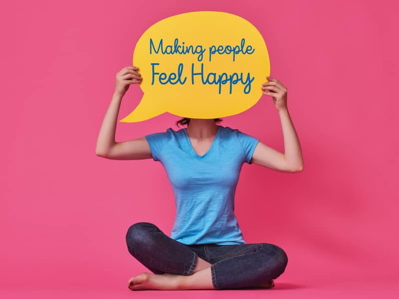 woman holding happy speech bubble