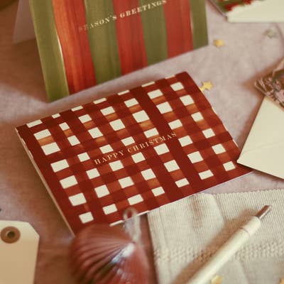 an adorable, red gingham patterned christmas card with gold foiling