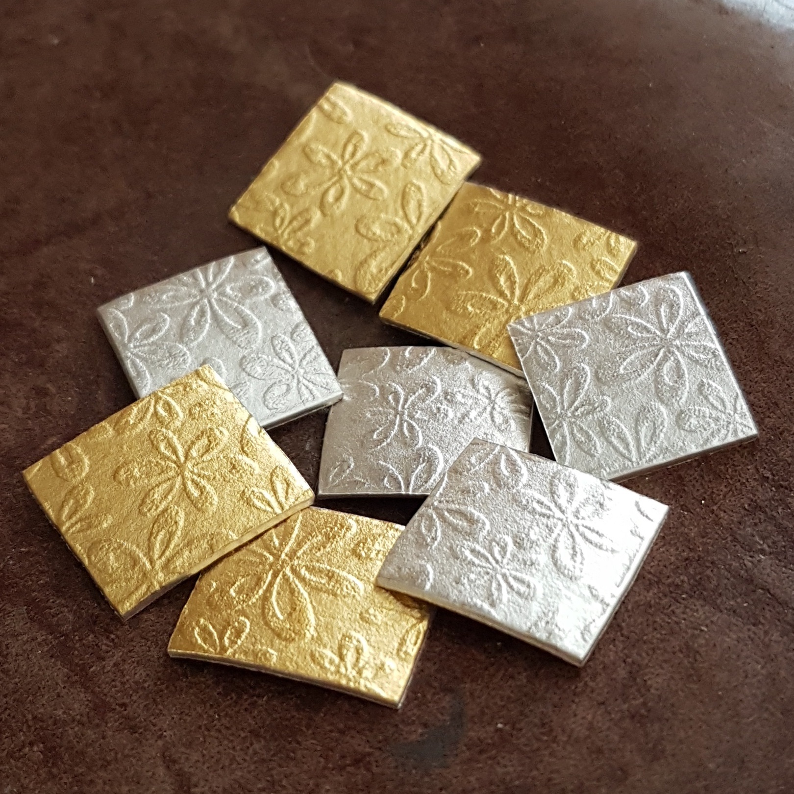 Watercolour gold and silver earrings being made