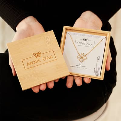 Geometric Bee Necklace from our dynami collection in an engraved bamboo box