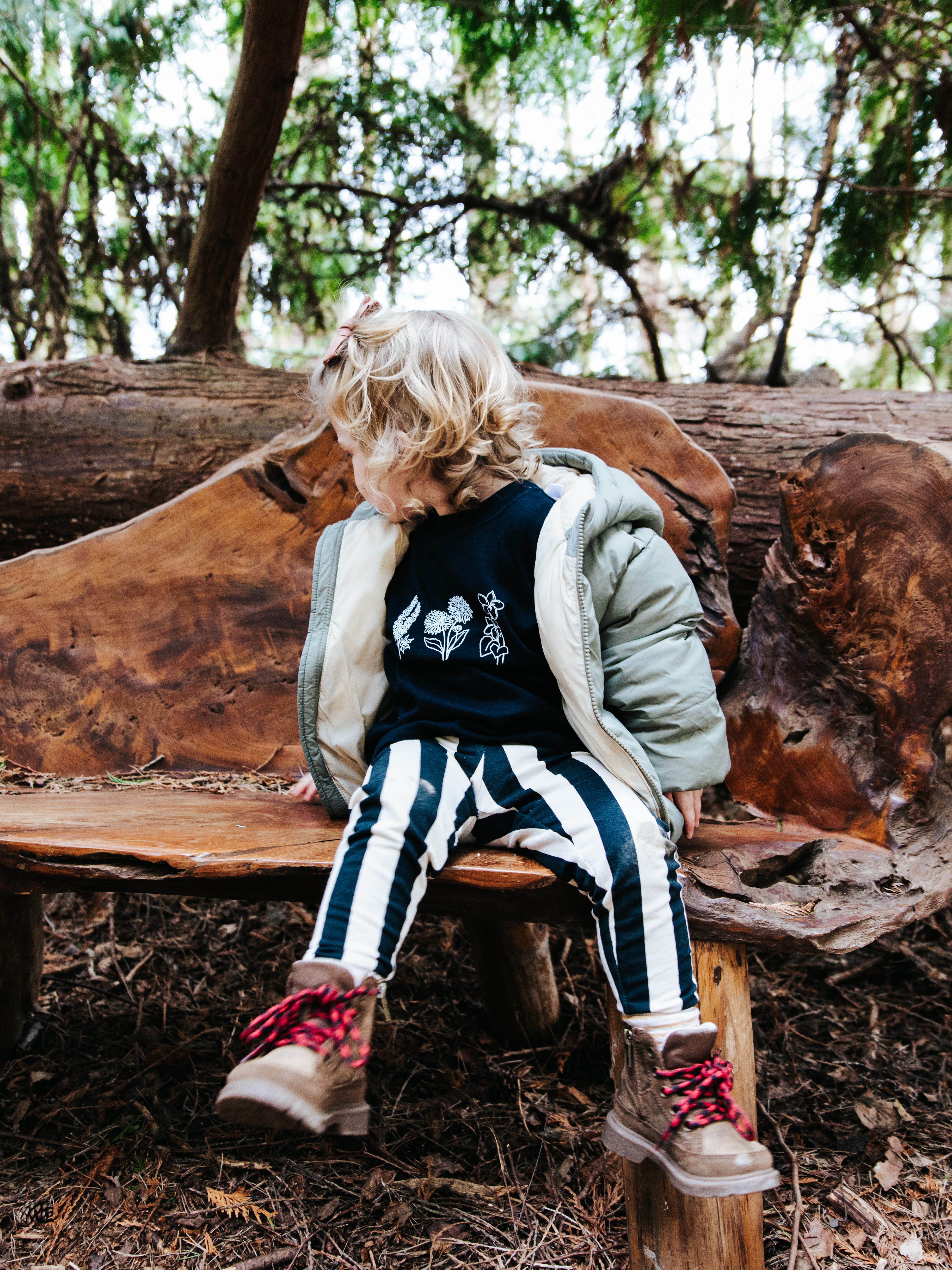 Little girl wearing a family birth month flower t shirt.