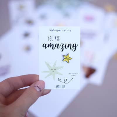 Blonde Lady holding a wheelbarrow with pumpkins inside with a bright blue sky.