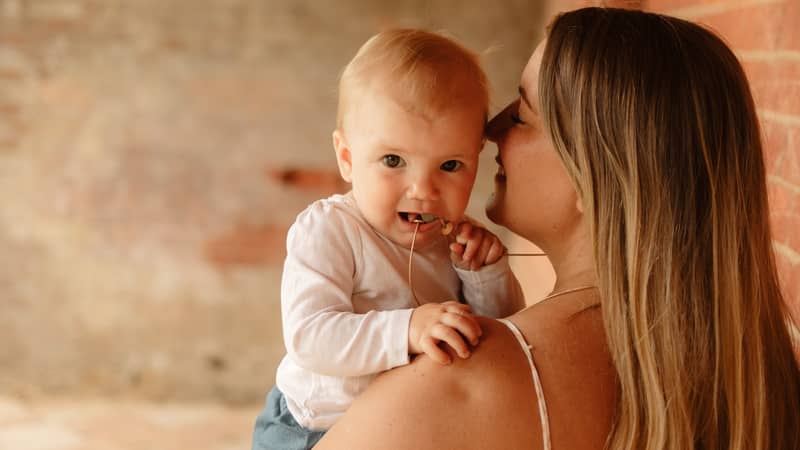 Mama wearing teething pendant