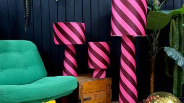 Three striped lamps next to green chair