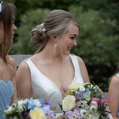 Beautiful bride wearing hand-beaded earrings