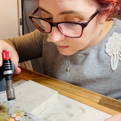 Jen Lithgo - Jen soldering a scatter leaf necklace together