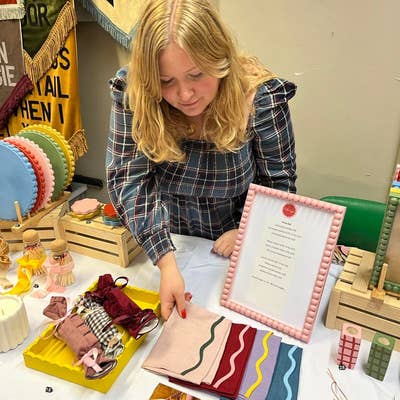 Founder of sugar & cement, Gemma standing behind her first market stall where the brand really started