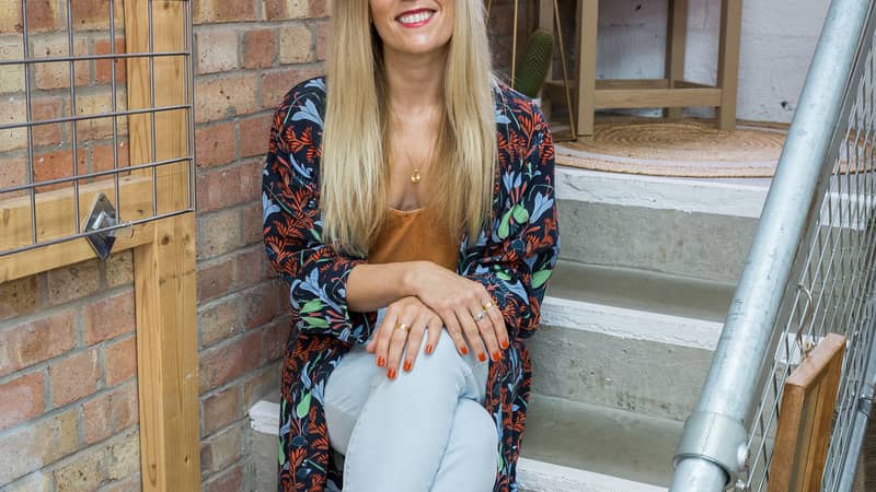 Business owner sitting on shop stairs