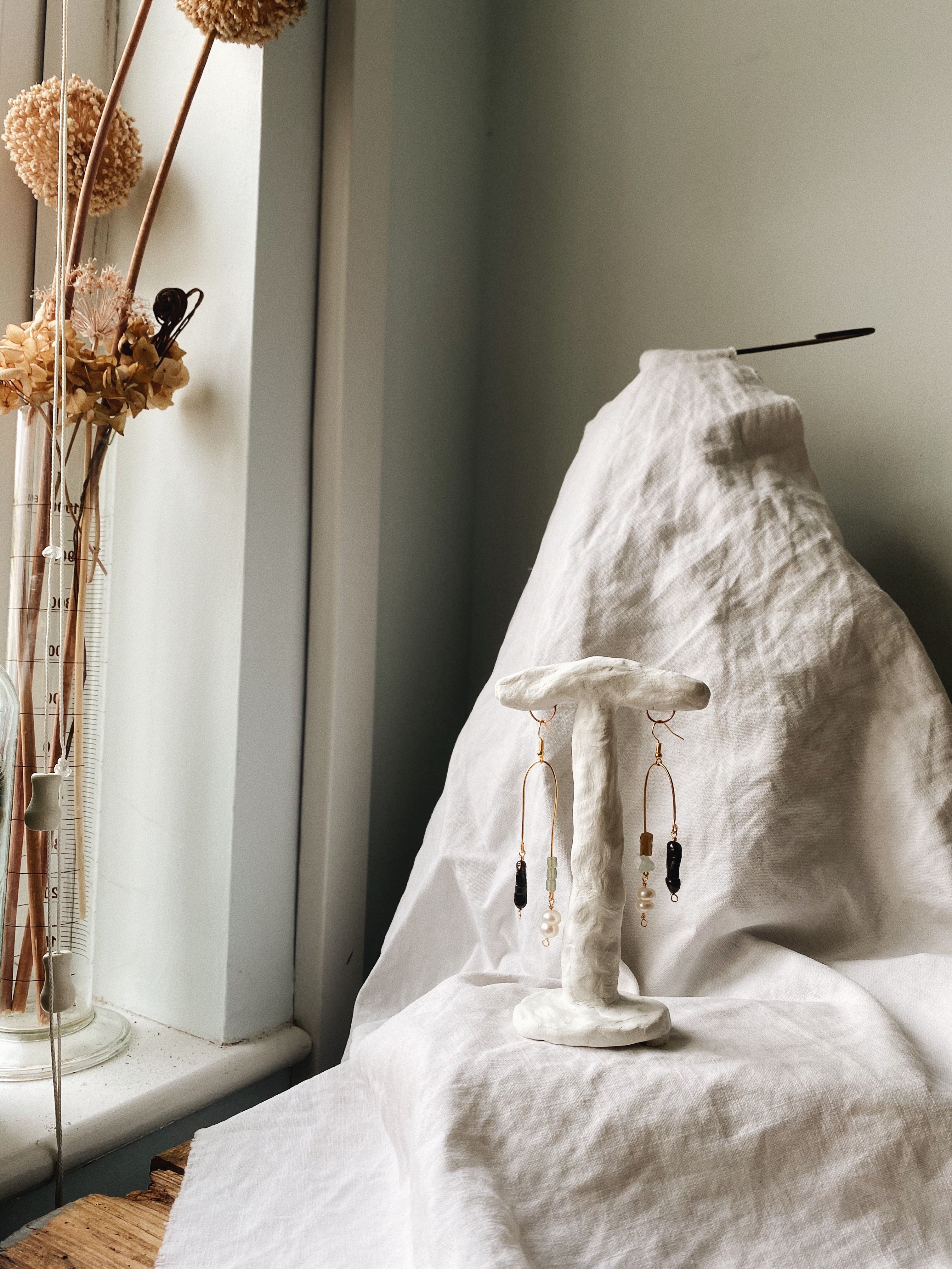 Studio shot of asymmetrical semi precious stone Edaisyt earrings