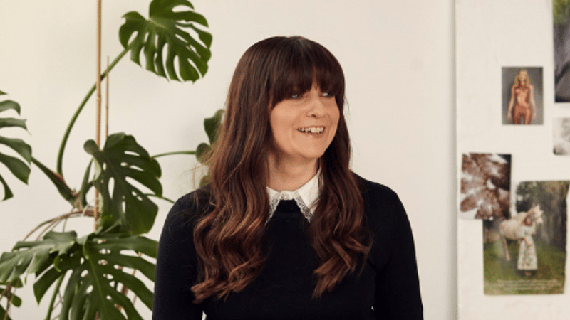 Our founder Paula sitting on a desk