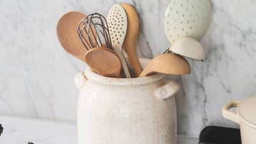 Kitchen pot with utensils inside