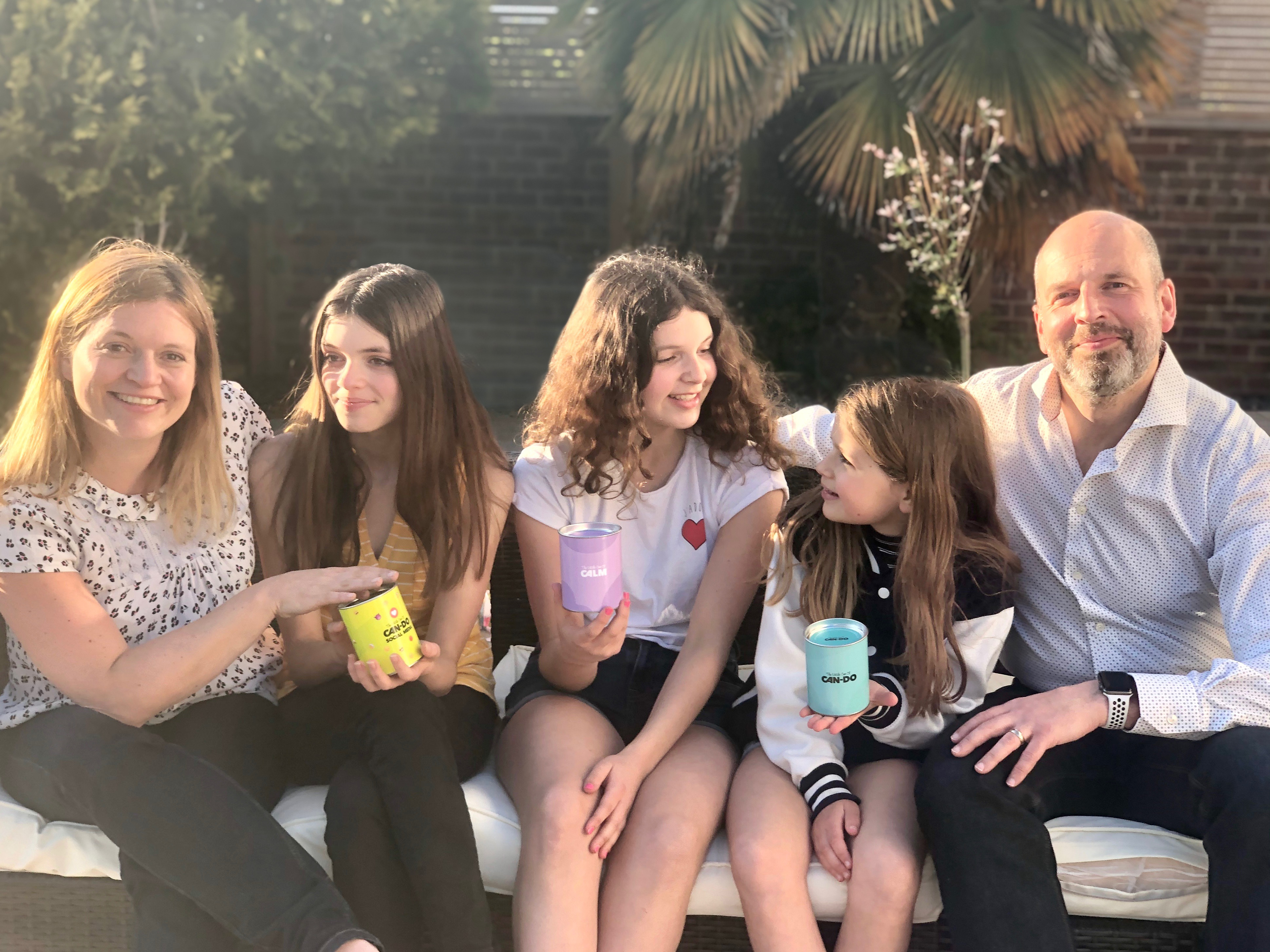 Family holding cans of mindfulness for children