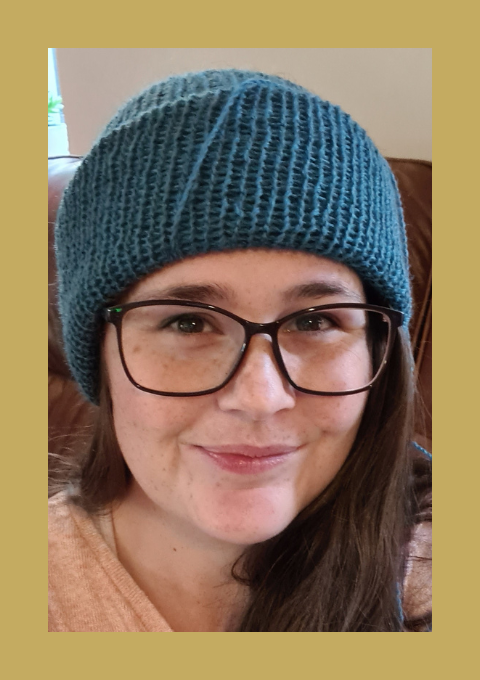 A picture of the maker in a handmade blue hat