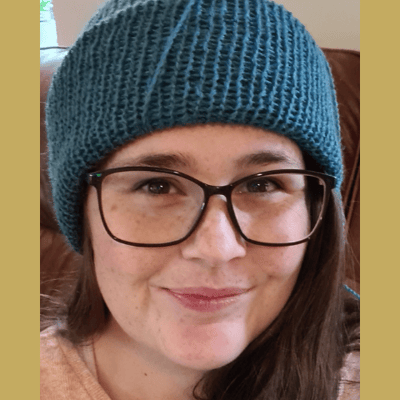 A picture of the maker in a handmade blue hat