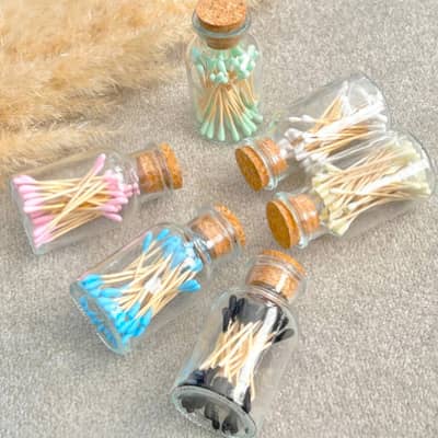 colourful cotton buds in a mason glass jar. Ear sticks and a-tips in various colours set in a mini glass jar.
