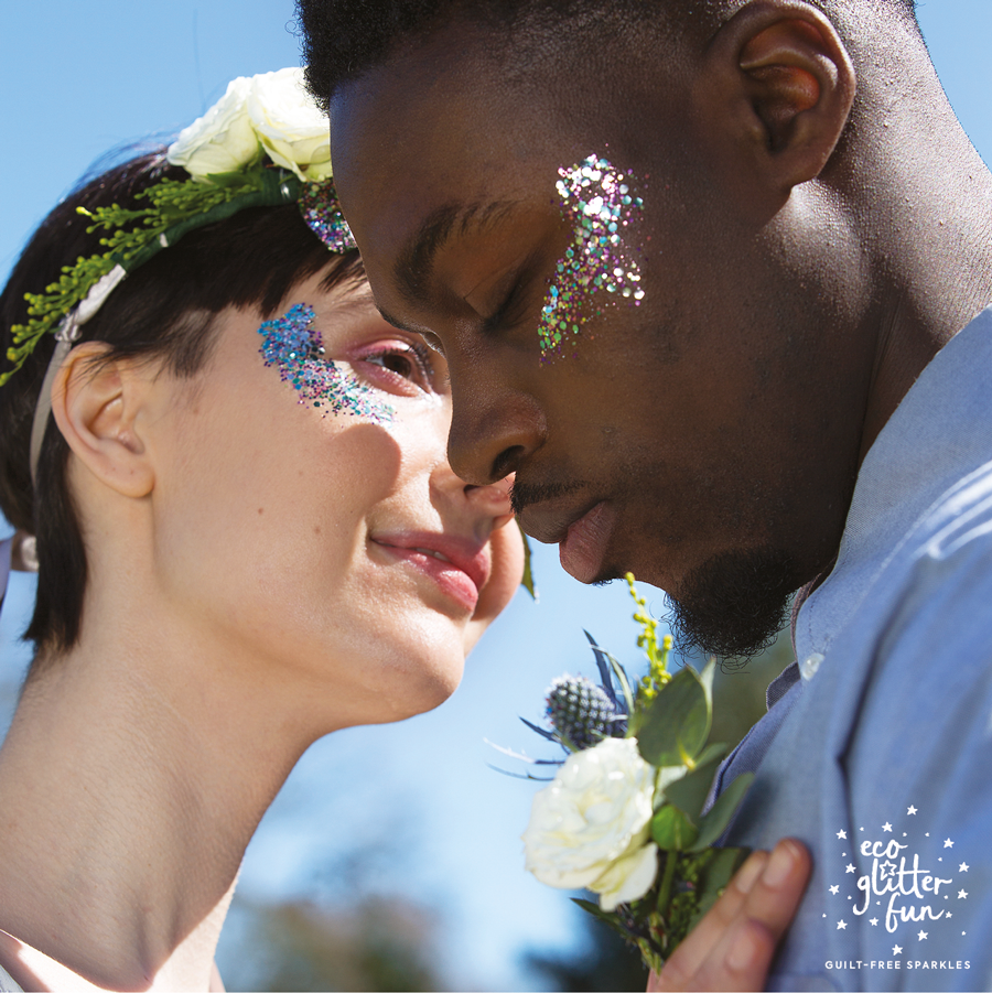 a couple on their wedding day with glitter on their cheeks 