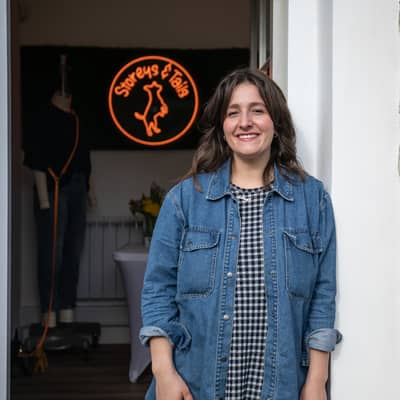 Natasha holding one of her dog collars in her studio