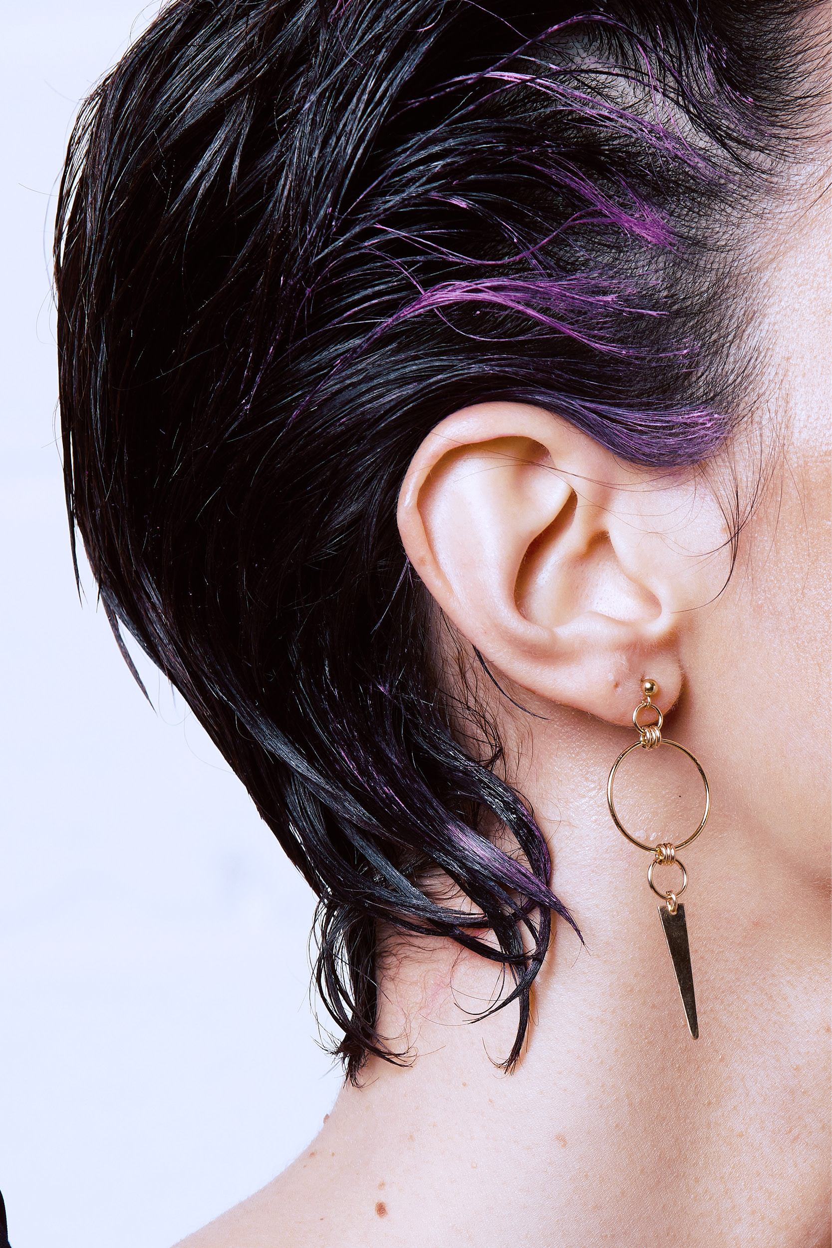 Model image with earrings with spikes and studs, gold