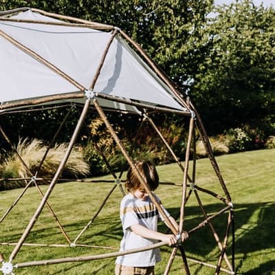 A young boy helps to build the geodesic garden pod