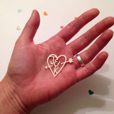 A paper cut heart in a woman's hand